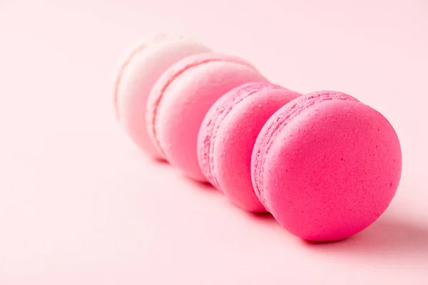 Selective focus of sweet colorful macarons on pink surface — Stock Photo