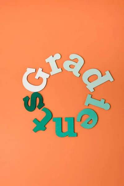 Top view of colorful letters on orange surface — Stock Photo