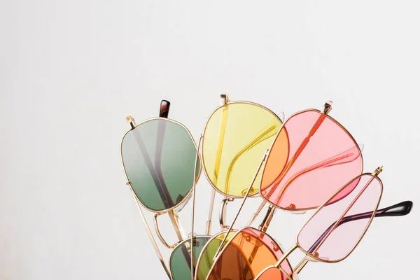 Top view of stylish colorful sunglasses on white — Stock Photo