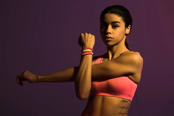 Sportive young african american woman looking at camera isolated on purple — Stock Photo