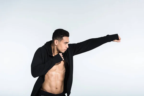 Handsome mixed race man in black sports jacket warming up on white — Stock Photo