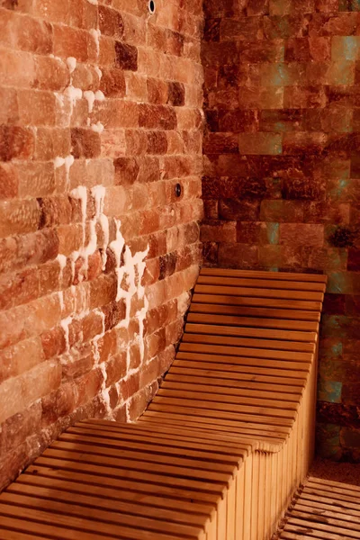 Banco de madeira no centro de spa com paredes texturizadas — Fotografia de Stock