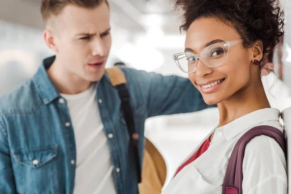 Two multiethnic students standing in corridor in university — Stock Photo