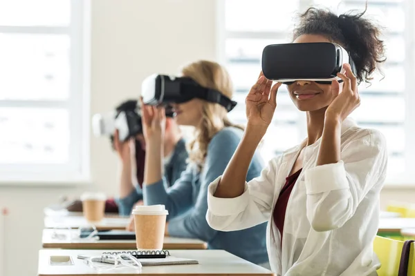 Selective focus of multiethnic students using vr headsets in university — Stock Photo