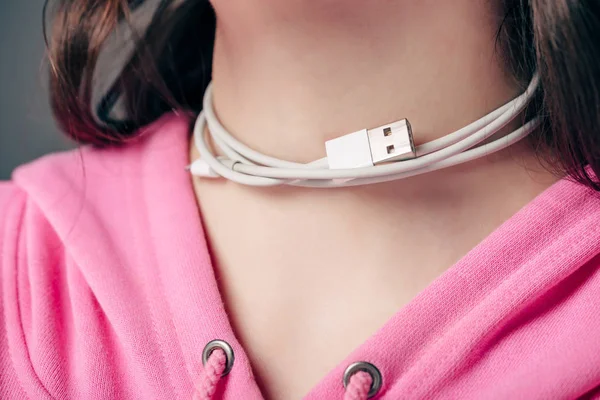 Partial view of young female with usb cable on kneck isolated on grey — Stock Photo