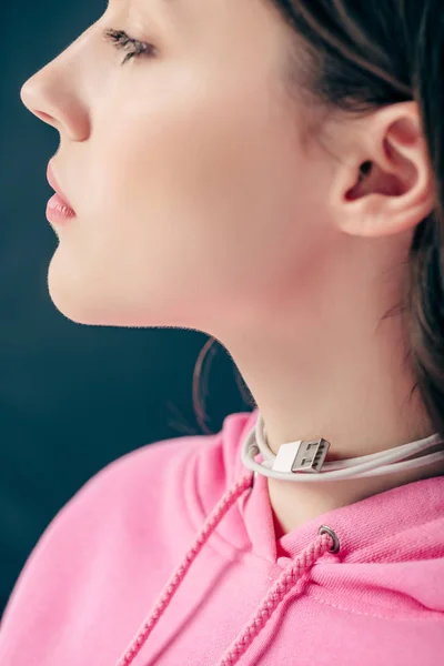 Pretty young girl with usb cable around neck isolated on green background — Stock Photo