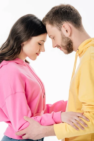 Pretty girl and handsome young man standing face to face with closed eyes isolated on white — Stock Photo