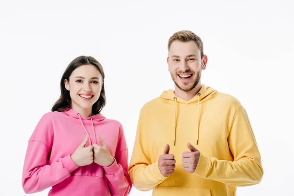 Young cheerful man and woman showing thumbs up while looking at camera isolated on white — Stock Photo