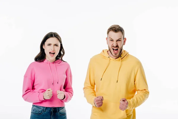 Young angry man and woman screaming while looking at camera isolated on white — Stock Photo