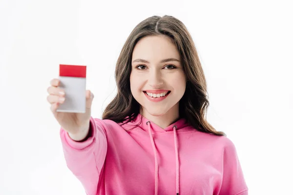 Selective focus of cheerful young woman holding cigarette pack isolated on white — Stock Photo