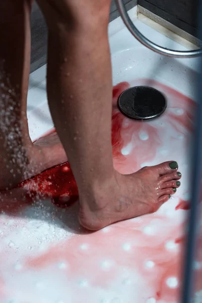 Partial view of barefoot bleeding woman in bathroom — Stock Photo