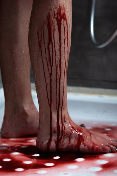 Partial view of barefoot bleeding woman in bathroom — Stock Photo