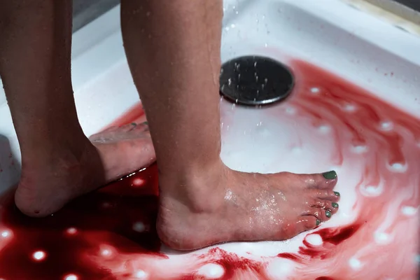 Cropped view of barefoot bleeding woman in bathroom — Stock Photo