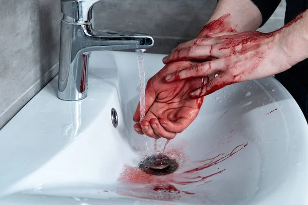 Partial view of man washing bleeding hands in sink — Stock Photo