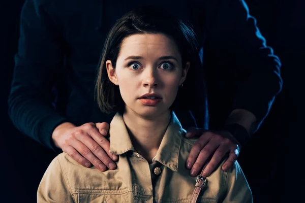 Cropped view of criminal attacking scared woman isolated on black — Stock Photo