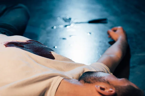 Partial view of dead man on floor at crime scene — Stock Photo