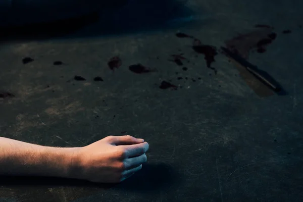 Partial view of dead man on floor at crime scene — Stock Photo