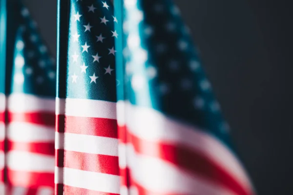 Selective focus of united states of america national flags isolated on black, memorial day concept — Stock Photo