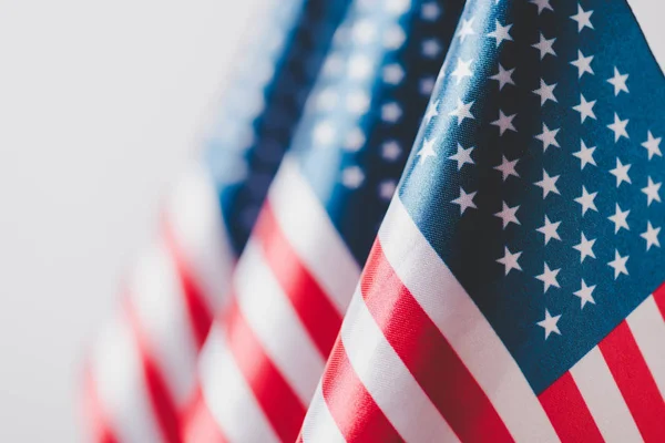 Selective focus of united states of america national flags isolated on grey, memorial day concept — Stock Photo