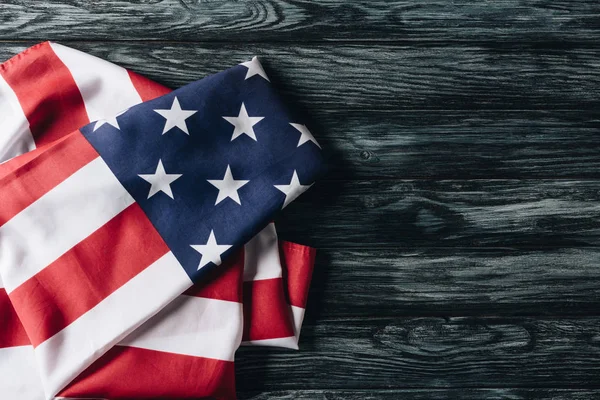 Folded flag of united states of america on grey wooden surface, memorial day concept — Stock Photo