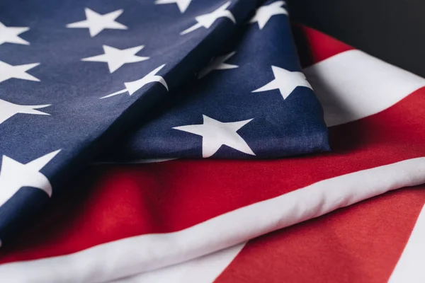 Plegado EE.UU. bandera nacional aislado en negro, memorial concepto de día — Stock Photo