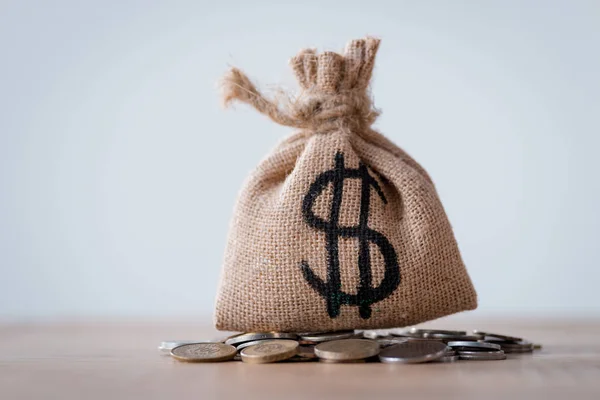 Sackcloth money bag with dollar sign and metal coins isolated on grey — Stock Photo