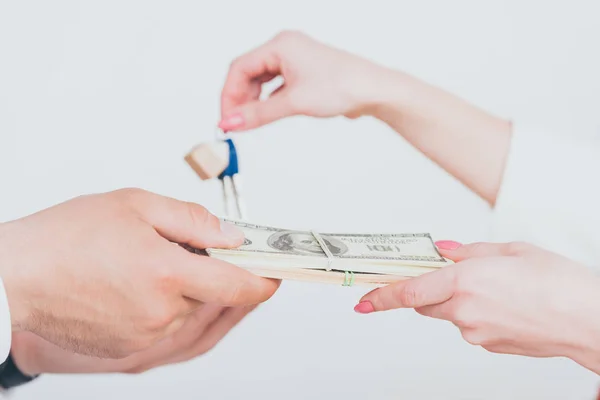 Cropped view of realtor taking money from client and giving key isolated on grey — Stock Photo