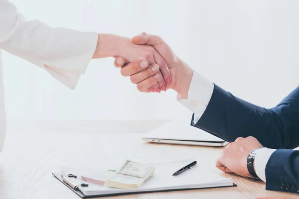 Partial view of woman and businessman shaking hands in office — Stock Photo