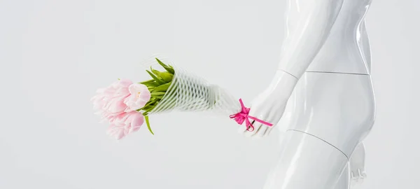 Panoramic shot of mannequin doll with bouquet of tulips isolated on grey — Stock Photo