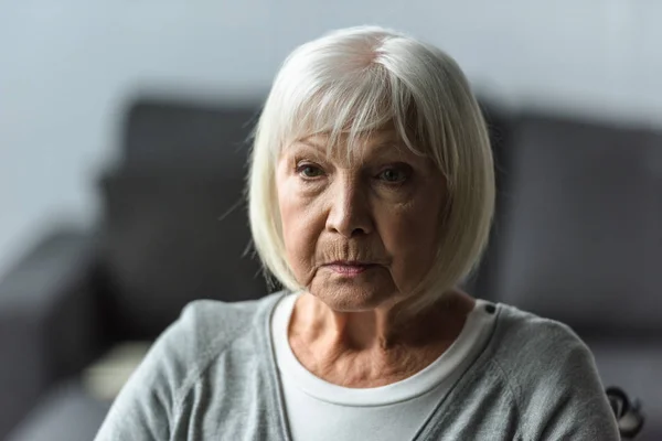 Pensive senior woman with grey hair looking away — Stock Photo