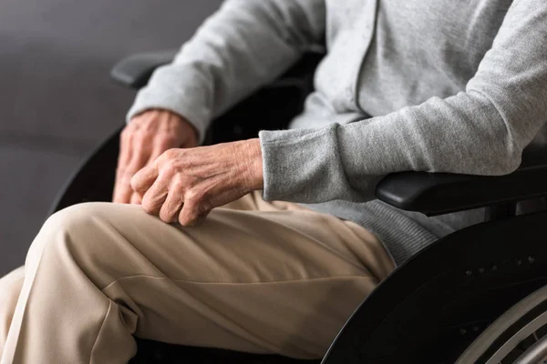 Partial view of disabled senior woman on wheelchair — Stock Photo