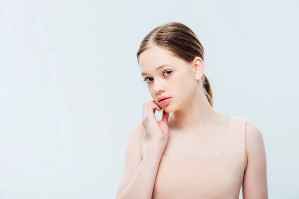 Worried teenager looking at camera and touching face isolated on grey with copy space — Stock Photo