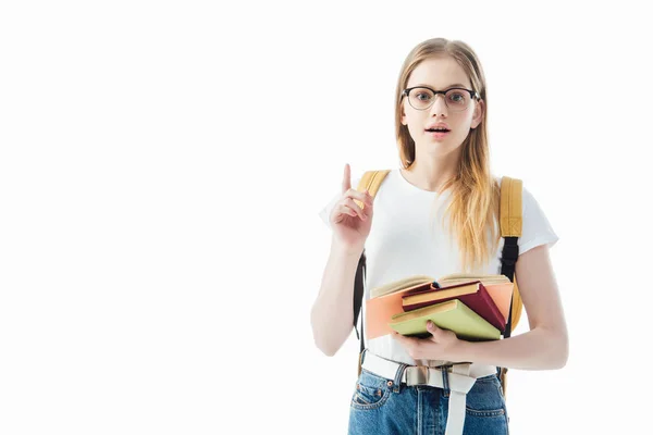 Excited schoolgirl with books and backpack showing idea gesture isolated on white — Stock Photo