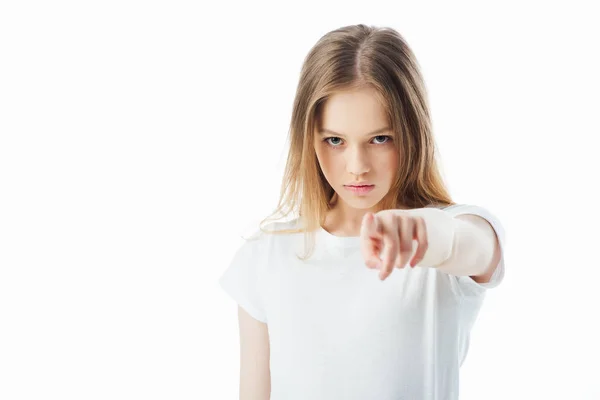 Selective focus of offended teenage girl pointing with finger at camera isolated on white — Stock Photo