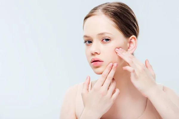 Sad teenage girl having acne on cheek isolated on grey — Stock Photo