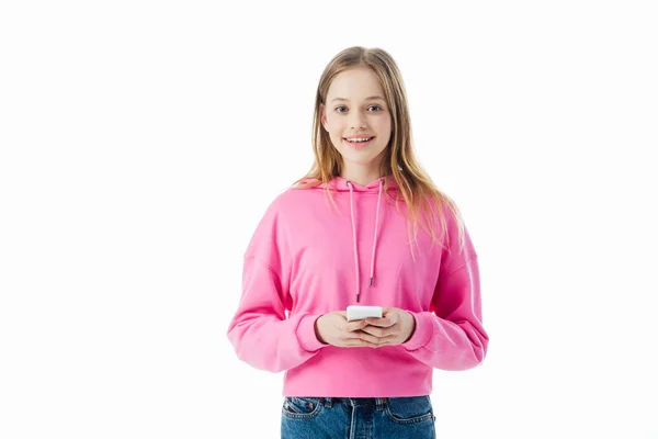 Happy teenage girl in pink hoodie holding smartphone isolated on white — Stock Photo