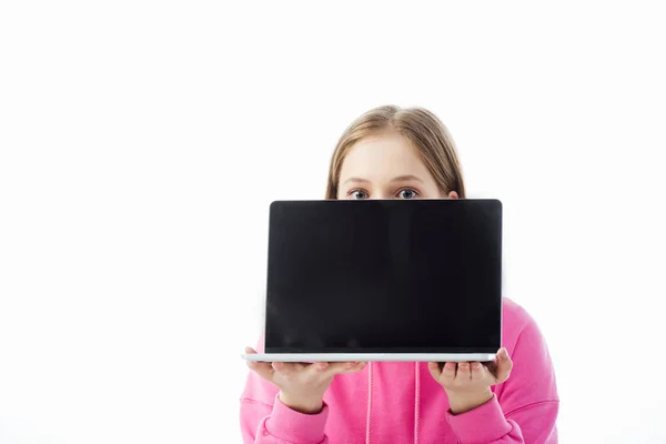 Teenage girl with obscure face holding laptop with blank screen isolated on white, illustrative editorial — Stock Photo