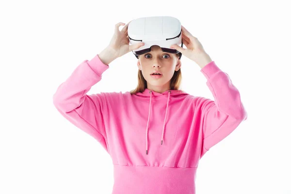 Shocked teenage girl in pink hoodie holding vr headset isolated on white — Stock Photo