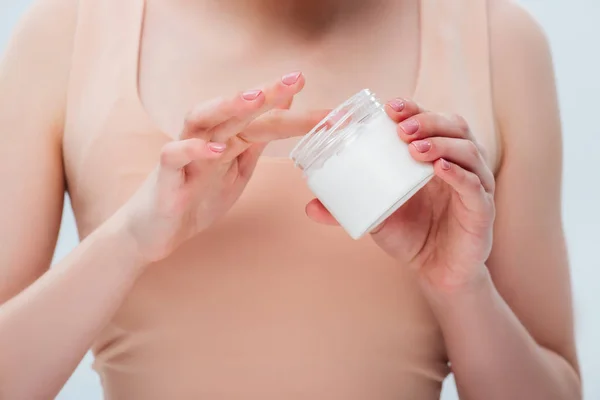 Visão cortada da menina adolescente aplicando creme cosmético nos dedos — Fotografia de Stock