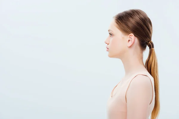Side view of serious teenage girl isolated on grey — Stock Photo