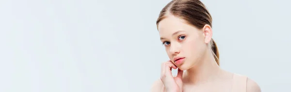 Pensive teenage girl looking at camera isolated on grey, panoramic shot — Stock Photo