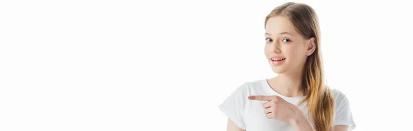 Plano panorámico de una adolescente sonriente señalando con el dedo aislado en blanco - foto de stock