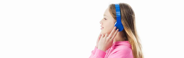 Side view of  teenage girl touching headphones on head isolated on white, panoramic shot — Stock Photo