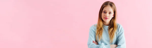 Panoramic shot of offended teenage girl with crossed arms isolated on pink — Stock Photo