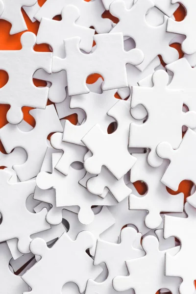 Close up of incomplete white jigsaw puzzle pieces — Stock Photo