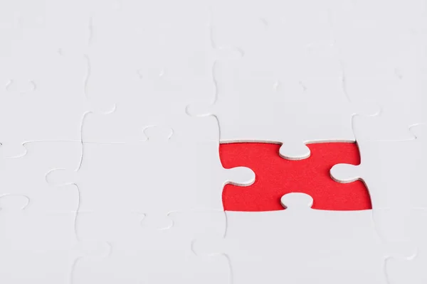 Selective focus of unfinished white jigsaw puzzle pieces — Stock Photo