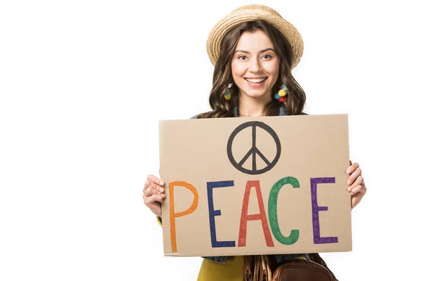Front view of smiling hippie girl in straw hat holding placard with inscription isolated on white — Stock Photo