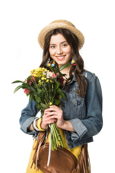 Happy boho girl in straw hat holding flowers isolated on white — Stock Photo