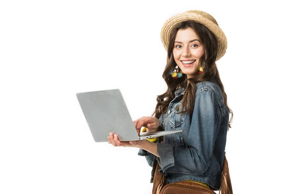 Cheerful boho girl in boater holding laptop isolated on white — Stock Photo