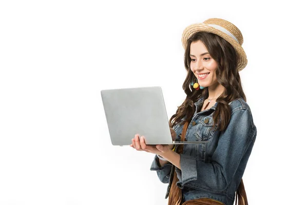 Cheerful boho girl in boater using laptop isolated on white — Stock Photo